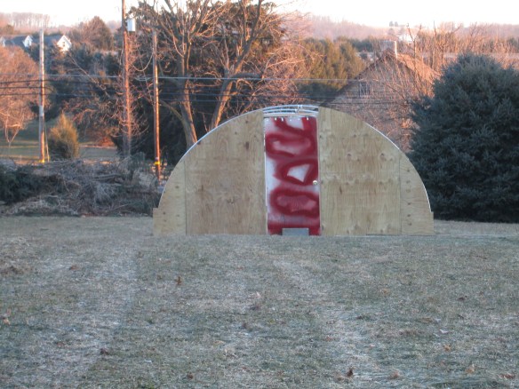 Glenn donated his graffiti-door to the cause. We hung it in place like that for a day, but don't worry, it's a nice happy green now.
